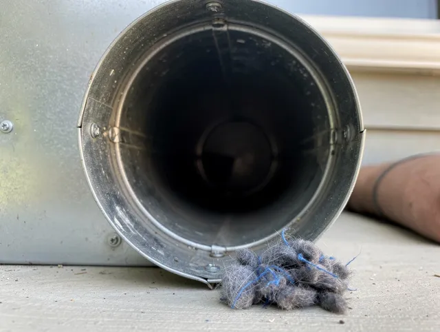 Concord Dryer Vent Cleaning technician using specialized equipment to clear severe dryer vent blockage in Concord